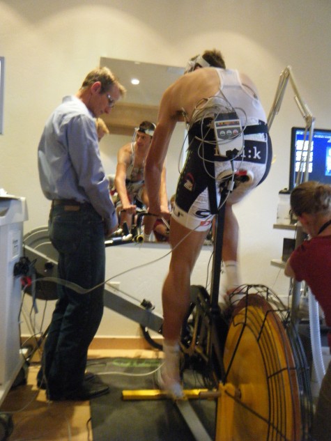 Coach Rick Crawford awaits the moment when he gets to prick pro racer, Neil Coleman's finger to obtain a blood lactate level.