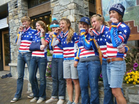 Coaches Sarah Sturm, 4th from left and Annie Cheeney, far right, take a bite into their Collegiate Team Gold Medal in California at the Collegiate National Championships