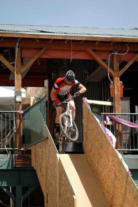 Coach Chad takes to the air at the Steamworks fun section in the Iron Horse cross country course. Photo by Jim Feilen